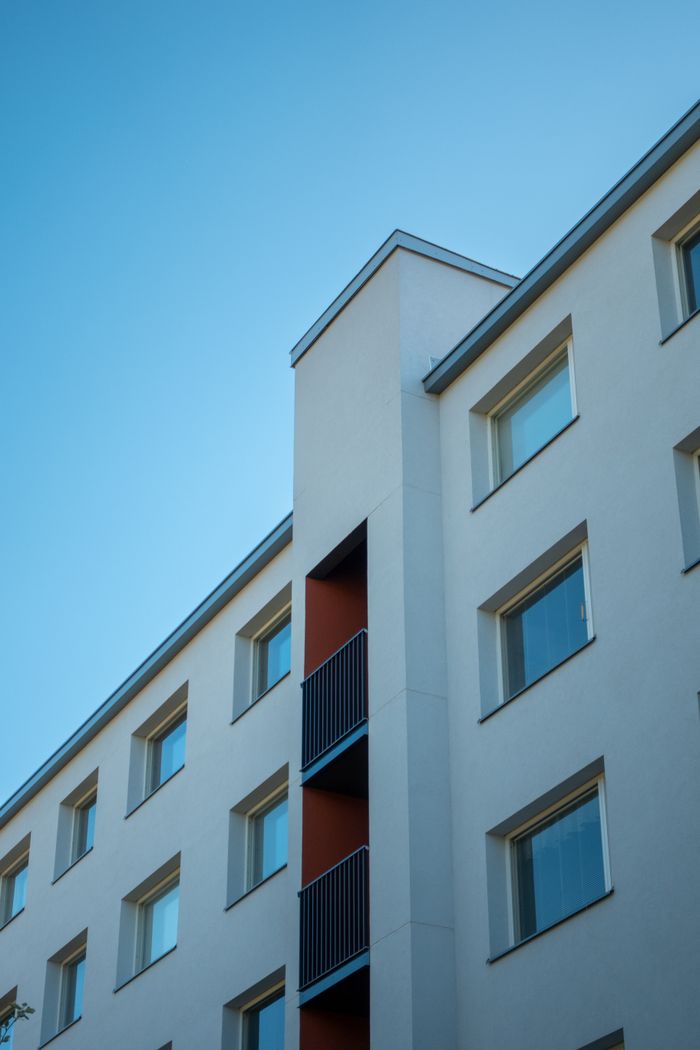 Angled view of a modern apartment building in Lahti, Finland, under a clear sky.